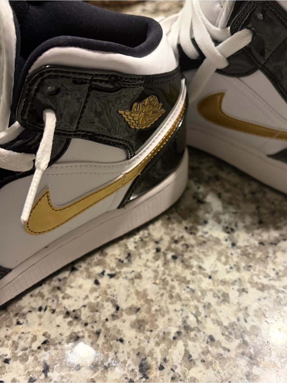 Air Jordan 1 Mid White Black Gold Sneakers